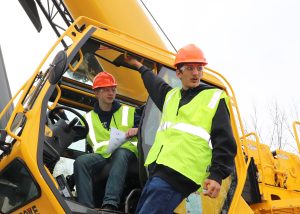 Students stand on a crane
