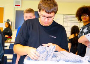 A student picks out his uniform