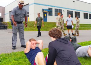 Trooper watches students do situps