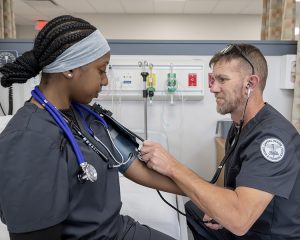 Adult students taking a blood pressure