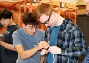 2 electrical students confer