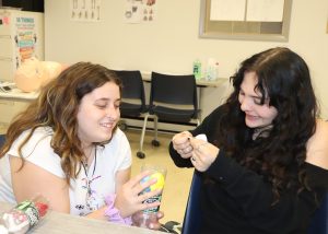 Two
students use modeling clay on a project