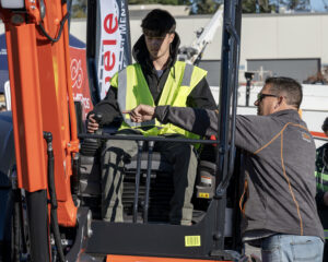 HERO student Jayden Leslie, Shaker, operates a Kubota from Abele Tractor with Greg Gainor.