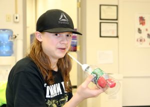 A student prepares to inflate a balloon