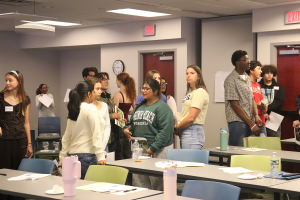 A diverse group of students talk about discussion agreements for the Elevating Student Voices program.
