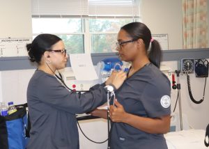 Adult students listen to a heart beat