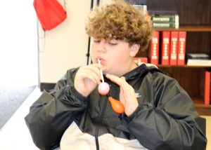 A student inflates a balloon